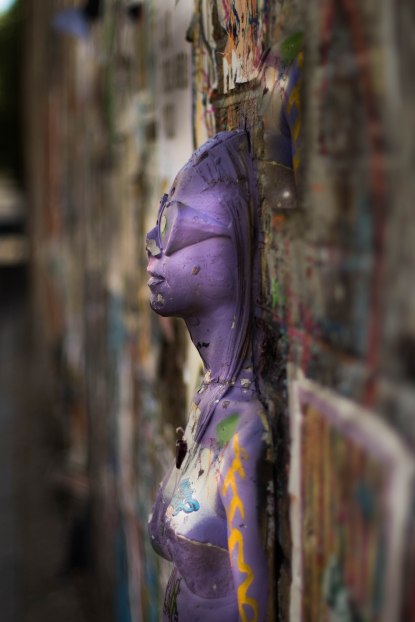 Purple relief figure in Brick lane, London